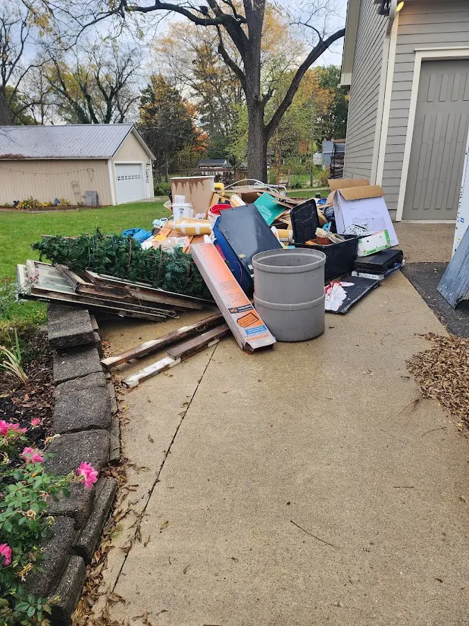 Dumpster being loaded with debris for 10 Yard Dumpster Rental in Midway South